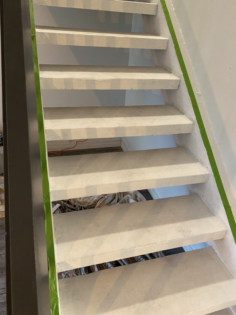 Steps with primer on them for staircase makeover